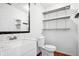 Bathroom featuring vanity, toilet, and storage shelves at 3127 W Sligh Ave # 204B, Tampa, FL 33614