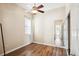 Cozy bedroom with hardwood floors, ceiling fan, and mirrored closet doors at 3127 W Sligh Ave # 204B, Tampa, FL 33614