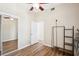 Bedroom featuring ceiling fan, door to hallway and a wardrobe rack at 3127 W Sligh Ave # 204B, Tampa, FL 33614
