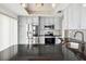 Updated kitchen with stainless steel appliances, granite countertops, and stylish gray cabinets at 3127 W Sligh Ave # 204B, Tampa, FL 33614