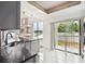 Bright kitchen featuring granite countertops, a breakfast bar and a view of the water at 3127 W Sligh Ave # 204B, Tampa, FL 33614