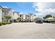 View of the well-maintained and lighted complex parking lot with reserved covered parking spots at 3127 W Sligh Ave # 204B, Tampa, FL 33614