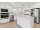 Modern kitchen featuring white cabinetry, stainless steel appliances, and center island at 6220 Golden Beach Dr, Apollo Beach, FL 33572