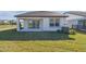 A covered patio and a well-maintained lawn create an inviting outdoor living space at 6240 Golden Beach Dr, Apollo Beach, FL 33572