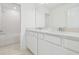 Bright bathroom featuring double sinks, quartz counters, and a shower/tub combo for convenience at 6240 Golden Beach Dr, Apollo Beach, FL 33572