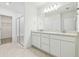 Elegant bathroom with double vanity, quartz countertop, large mirror, and a glass-enclosed shower at 6240 Golden Beach Dr, Apollo Beach, FL 33572