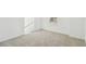Bright bedroom with neutral carpet, white walls, and natural light from a window with blinds at 6240 Golden Beach Dr, Apollo Beach, FL 33572
