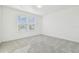 Bright bedroom with plush carpets, white walls, and large window providing natural light and charm at 6240 Golden Beach Dr, Apollo Beach, FL 33572
