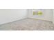 Serene bedroom featuring plush carpeting, bright window, and white walls for a tranquil atmosphere at 6240 Golden Beach Dr, Apollo Beach, FL 33572