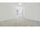 Cozy bedroom with neutral carpeting, white walls, a large window and closet for ample storage space at 6240 Golden Beach Dr, Apollo Beach, FL 33572