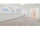Bright bonus room with three large windows that provide ample natural light and neutral decor at 6240 Golden Beach Dr, Apollo Beach, FL 33572