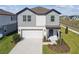Charming two-story home features a two-car garage and well-manicured lawn at 6240 Golden Beach Dr, Apollo Beach, FL 33572