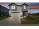 Inviting two-story home boasts a two-car garage, and manicured landscaping at 6240 Golden Beach Dr, Apollo Beach, FL 33572
