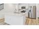 The kitchen features an island with quartz countertops and stainless steel appliances at 6240 Golden Beach Dr, Apollo Beach, FL 33572