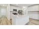 Bright kitchen boasts white cabinets, stainless steel appliances, and a center island at 6240 Golden Beach Dr, Apollo Beach, FL 33572