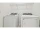 Convenient laundry room featuring modern washer and dryer, plus added shelf storage for organized living at 6240 Golden Beach Dr, Apollo Beach, FL 33572