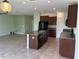 Modern kitchen featuring stainless steel appliances, granite countertops, and a central island sink at 7119 Salt River Ave, Sun City Center, FL 33573