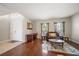 Living room with hardwood floors, a brown leather couch, and a wooden coffee table at 17905 Machair Ln, Land O Lakes, FL 34638