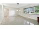 Spacious living area with access to bathroom and terrazzo floor at 1756 Ashton Abbey Rd, Clearwater, FL 33755