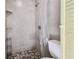 Clean bathroom with shower, toilet, and pebble floor at 1756 Ashton Abbey Rd, Clearwater, FL 33755