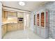 Galley kitchen with wood cabinets and brick accent wall at 1756 Ashton Abbey Rd, Clearwater, FL 33755