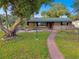 1-story home with landscaped yard and walkway at 1756 Ashton Abbey Rd, Clearwater, FL 33755