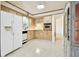 Retro kitchen with wood cabinets and terrazzo floor at 1756 Ashton Abbey Rd, Clearwater, FL 33755