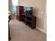Main bedroom with TV and dresser at 16015 Cape Coral Dr, Wimauma, FL 33598