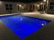 Night view of the pool with blue lighting at 16015 Cape Coral Dr, Wimauma, FL 33598