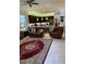Spacious living room with leather furniture and a large area rug at 16015 Cape Coral Dr, Wimauma, FL 33598