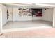 Spacious garage with overhead storage and epoxy floor at 16015 Cape Coral Dr, Wimauma, FL 33598