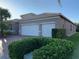 One story home with three car garage and manicured hedges at 16015 Cape Coral Dr, Wimauma, FL 33598