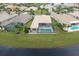 Community pool and patio area with surrounding homes at 16015 Cape Coral Dr, Wimauma, FL 33598