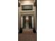 Double front doors with glass panels and fall decor at night at 16015 Cape Coral Dr, Wimauma, FL 33598
