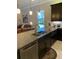 Kitchen boasts a large island with granite countertops and stainless steel appliances at 16015 Cape Coral Dr, Wimauma, FL 33598