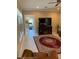 Living room with fireplace and access to home gym at 16015 Cape Coral Dr, Wimauma, FL 33598