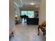 Spacious living area showcasing a grand piano, comfortable seating, and marble floors at 16015 Cape Coral Dr, Wimauma, FL 33598