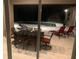 Night view of the pool and patio furniture at 16015 Cape Coral Dr, Wimauma, FL 33598