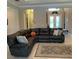 Relaxing living room with a sectional sofa, area rug, and ample natural light at 16015 Cape Coral Dr, Wimauma, FL 33598