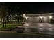 Two story home with three car garage, lit at night at 16015 Cape Coral Dr, Wimauma, FL 33598