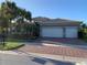 Two-story home with three-car garage and manicured landscaping at 16015 Cape Coral Dr, Wimauma, FL 33598