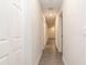 Bright hallway with gray vinyl plank flooring and neutral walls at 10112 Midway St, Gibsonton, FL 33534