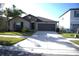 One-story house with brown garage door and landscaping at 7119 Salt River Ave, Sun City Center, FL 33573