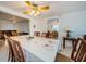 Bright dining room with table and chairs, view into living room at 1551 Derrick St, Holiday, FL 34690