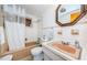 Bathroom with tub, sink, and a large mirror at 1551 Derrick St, Holiday, FL 34690