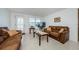 Living room featuring brown couches and a coffee table at 1551 Derrick St, Holiday, FL 34690