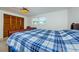 Bedroom with double bed, wood dresser, and large closet at 1551 Derrick St, Holiday, FL 34690