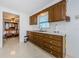 Kitchen featuring wood cabinets, white appliances, and a sink at 1551 Derrick St, Holiday, FL 34690
