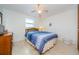 Bedroom with wood bed frame and tiled floors at 1551 Derrick St, Holiday, FL 34690