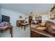Open living room with brown couches, and view to dining area at 1551 Derrick St, Holiday, FL 34690